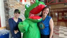 Two triathalon participants pose with Gator mascot