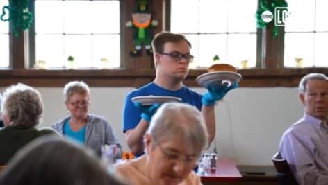 A waiter brings food to customers at the So Much To Give Inclusive Cafe in Skippack.