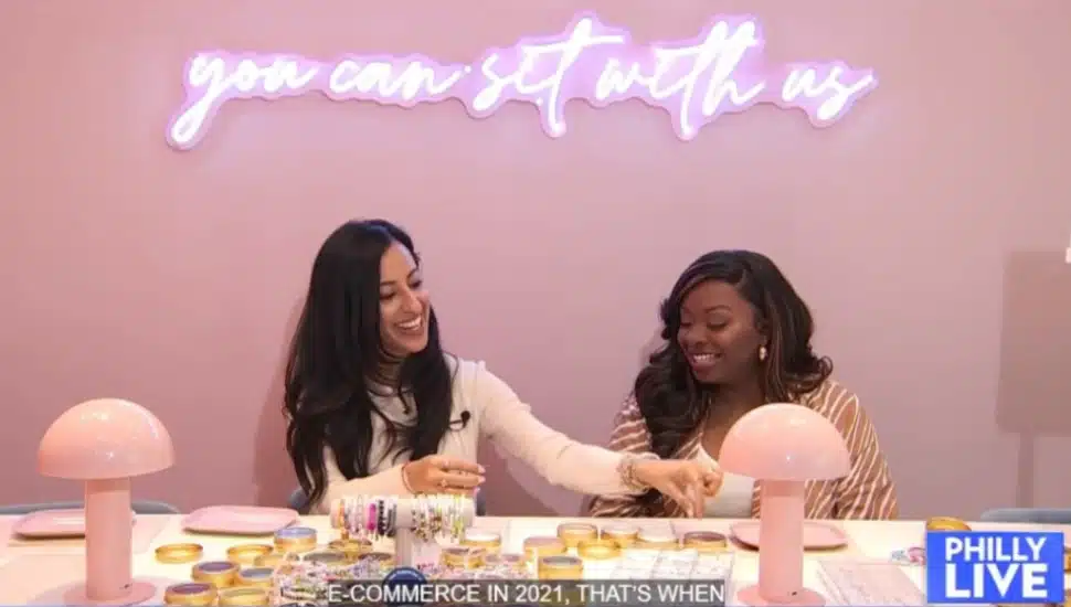 Founder and CEO Adrianna Carrig for Little Words Project works on a friendship bracelet with NB 10 reporter Aunyea Lachelle in her new King of Prussia store.