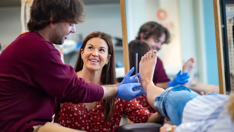 Student in the Orthotics and Prosthetics (O&P) program evaluating a foot