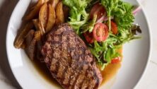 steak, salad, fries on plate from Serum