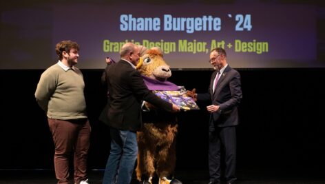 West Chester University mascot Rammy presents original student artwork to West Chester University President Dr. Chris Fiorentino for his decades of service on their behalf. The artwork was created by Shane Burgette, a graduating graphic and design major.