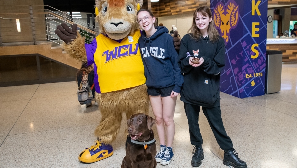 WCU mascot Rammy, Muddle Puddles, and several student well-wishers.