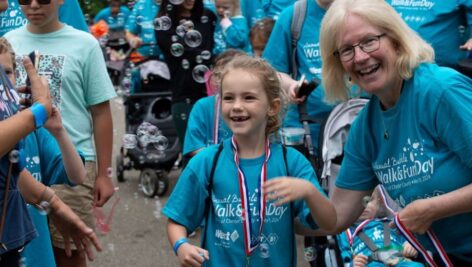 Arc of Chester County CEO Jeanne Meikrantz honors a young walker.at the May 19, 2024 Bubble Walk & Fun Day.