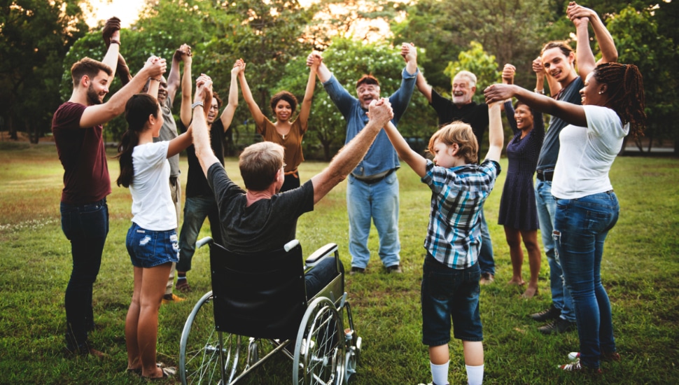 Group of people holding hands together