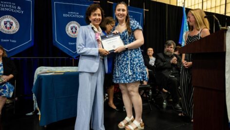 Kaitlyn Cross, HFU's Class of 2024 Valedictorian, on stage at Holy Family University's graduation ceremony.