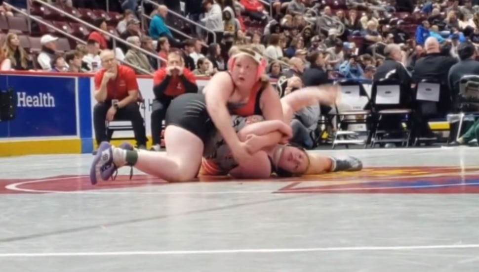 MacKenna Atkinson defeats fellow wrestler Aja'nai Jumper during a match.