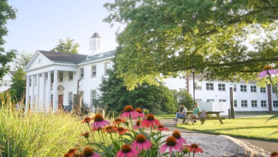 Image of DelVal campus with flowers blooming in front.