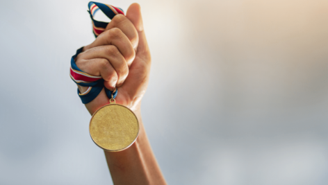 person holding gold medal