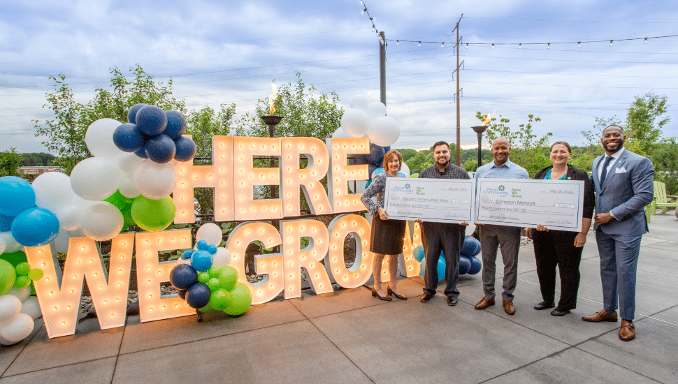 Light up letters reading "Here we grow" at Penn Community Bank's May 29 networking mixer.