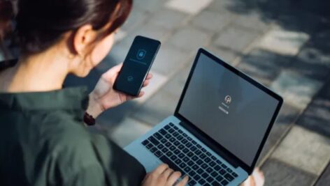 Woman online using public wifi, indicating the risk of the dark web.