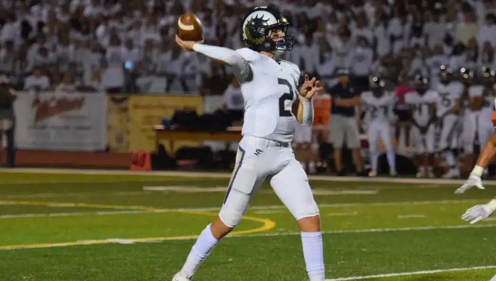 Matt Zollers throwing a football.