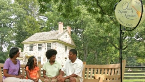 Group sitting/listening at one of the Once Upon A Nation benches at Valley Forge National Historical Park.