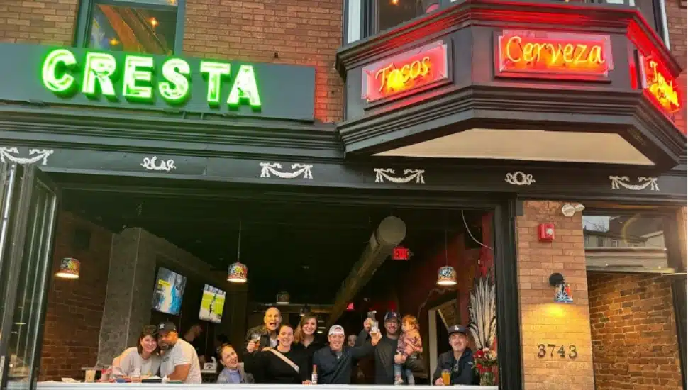 Image of the outside of Taqueria Falls with a group of people gathered at the entry.