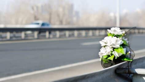 A memorial of flowers was placed at the site of a fatal traffic accident.