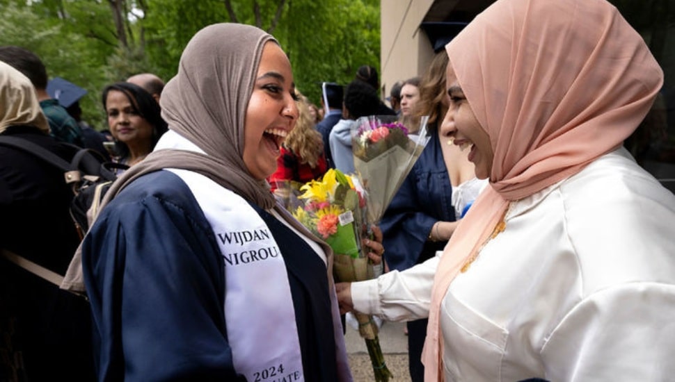 two women at Penn State Abington's commencement ceremony.