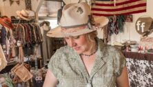 Tanna Walker wearing one of her hats in her shop.