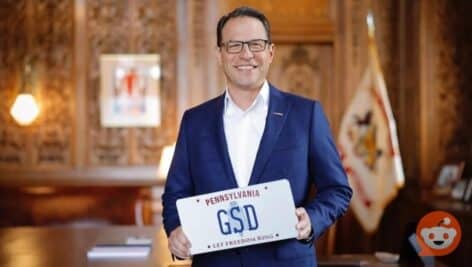 Gov Josh Shapiro holding a GSD Pennsylvania License Plate.