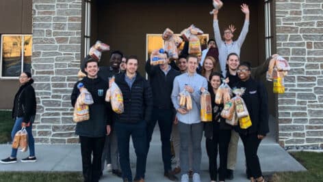 People hold bags of Bimbo bread.