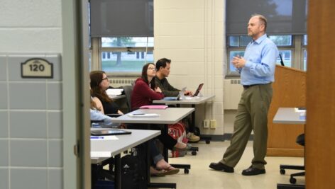 A professor in a classroom at Immaculata University lecturing students.