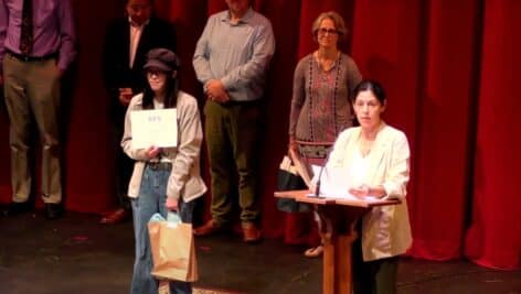 An AFS student on stage receiving an award.