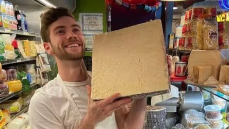 Champion cheesemonger Jake Heller holds a block of cheese at Perrystead Dairy and Downtown Cheese.