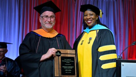 Physics Instructor Douglas Vardakas stands with Dr. Chae Sweet, Vice President of Academic Affairs and Provost at Commencement. Vardakas was named the 2024 recipient of the Lindback Distinguished Teaching Award.