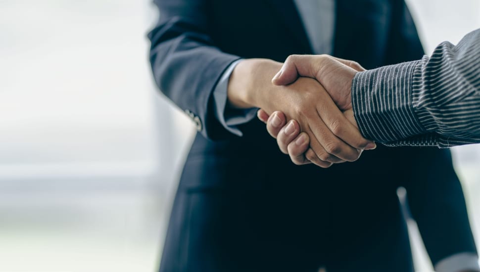 two people shaking hands after a deal