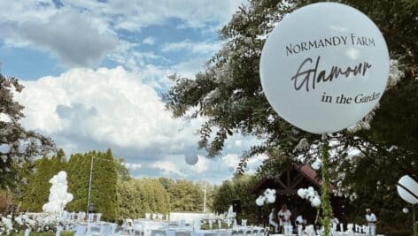 White balloons, tables and chairs set up for Normandy Farm's Glamour in the Garden