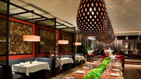 A large wooden table stretches down the length of the Azie on Main dining room