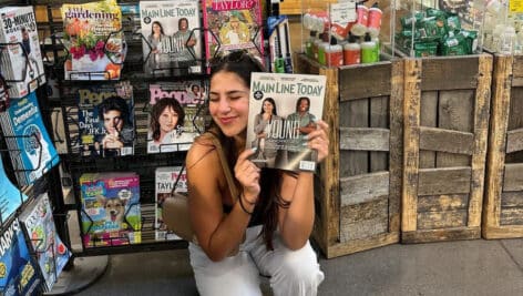 Lizzy Friedman holds copy of "Main Line Today" with her picture on it.