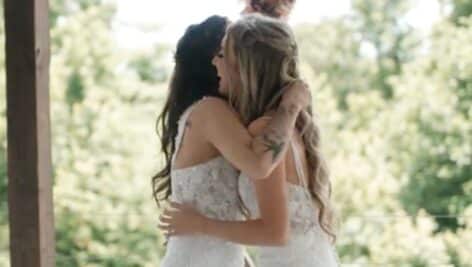 Two brides hugging