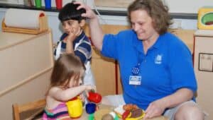 Early Child Care teacher playing with children