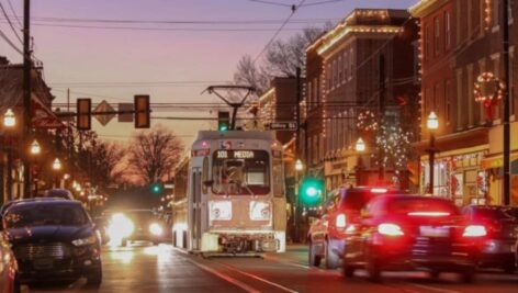 A trolley cruises down State Street amid traffic in Media Borough