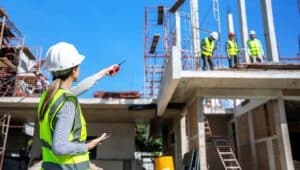 Supervisor points to laborers at a construction site