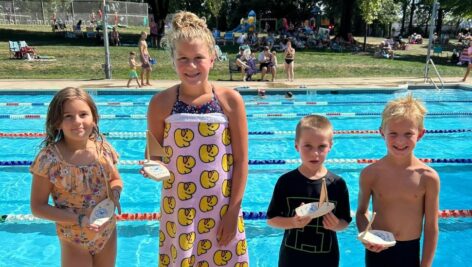 Winners display their trophies for the Cardboard Boat Regatta