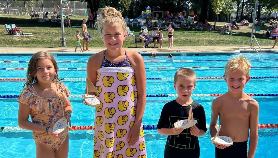 Winners display their trophies for the Cardboard Boat Regatta