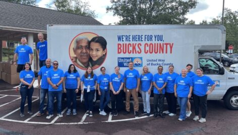 Volunteers gather around truck of United Way of Bucks County.