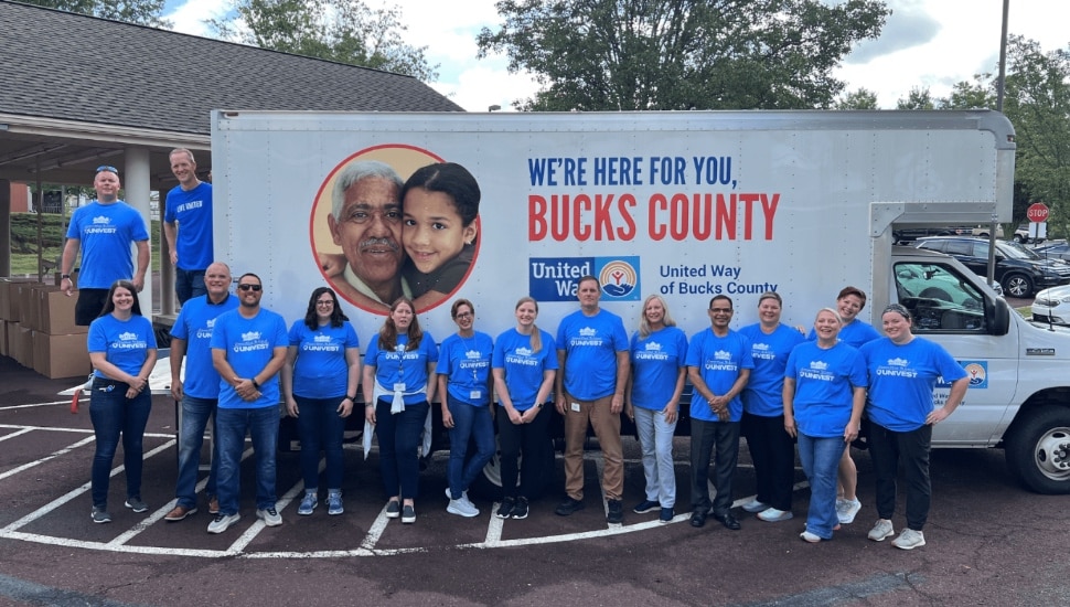 Volunteers gather around truck of United Way of Bucks County.