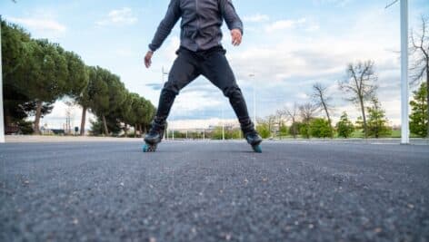 Man roller skating down the street.