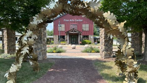 An arched oak leaves outdoor installation outside the Fine Arts Center. Sculpture exhibitions at Blue Bell and Pottstown campuses will kick off the fine arts season.