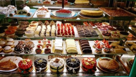 A bakery display with an assortment of sweets and baked goods.