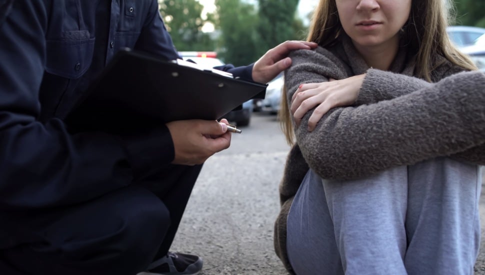 A police officer speaking with troubled youth.