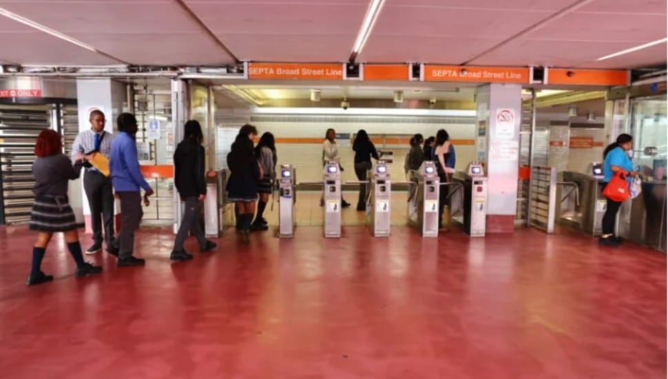 Commuters walk through the turnstiles at SEPTA.