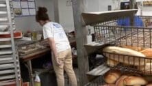 Tina Gambone preparing a tomatop pie at Conshohocken Italian Bakery.