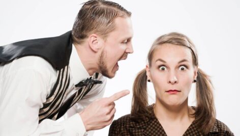 older man yelling at a younger woman