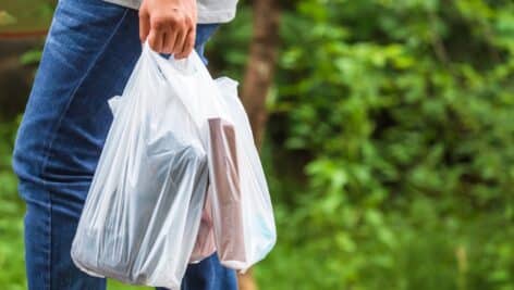 Woman carries plastic bags