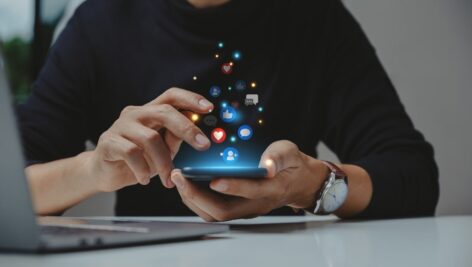 Man browses social media on his smart device.