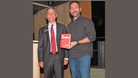 Meridian Bank CEO Chris Annas (L) pictured with Rich Diviney and his book, "The Attributes."