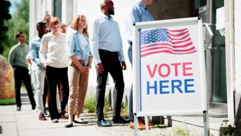 People gather in line to vote.